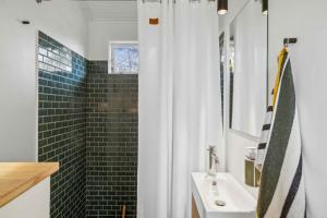 a bathroom with a sink and a shower at Charming Cottage In Raageleje in Vejby