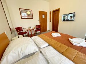 Postel nebo postele na pokoji v ubytování Apartmány Aurelius
