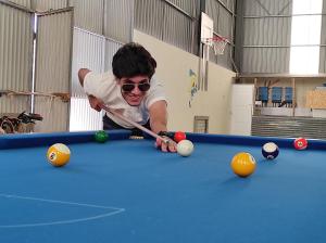 a man playing pool on a pool table at Quinta das Cantigas by Book YourHoliday PT in Aljubarrota