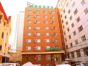 a tall orange building with chinese writing on it at GreenTree Inn HeBei QinHuangDao ChangLi County MinSheng Road Walking Street Express Hotel in Changli