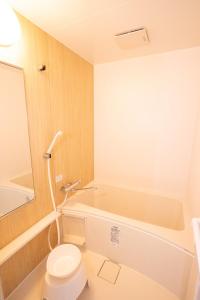 a bathroom with a toilet and a bath tub at MOMOYA tsudoi 和風 岡山清輝橋駅徒歩1分 貸切 駐車場付 in Okayama