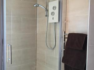 a bathroom with a shower with a glass door at Lakeview Guest House in Stranraer +75 photos