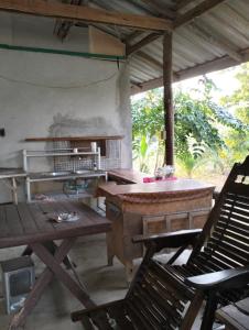 a room with chairs and a table and a table and chairs at Baan Saikuan in Phra Ae beach