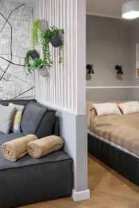 a living room with a couch and a bed at Sekwoja Rent - Malmeda 15 in Białystok
