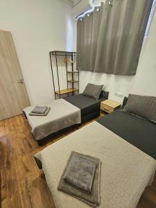 a room with three beds and a window at Beach Apartment B in Nea Karvali +55 photos