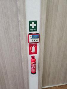 a door with a fire extinguisher sign on it at Beach Apartment B in Nea Karvali