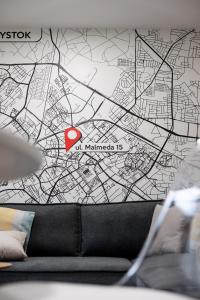 a map of a city on a wall with a couch at Sekwoja Rent - Malmeda 15 in Białystok