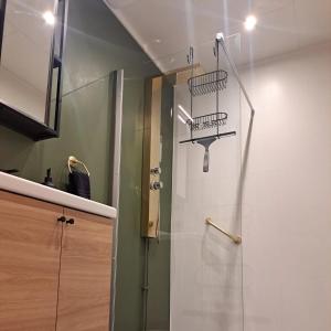 a shower with a glass door in a bathroom at Åbergs Gård - BnB Orsa Åberga in Kallmora
