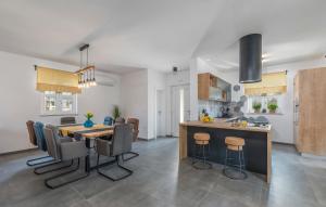 a kitchen and dining room with a table and chairs at Villa Terra Magica Heated Pool Sauna and Jacuzzi in Rapavel