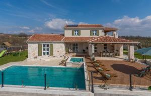 a house with a swimming pool in front of it at Villa Terra Magica Heated Pool Sauna and Jacuzzi in Rapavel