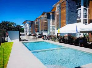 a swimming pool in front of a building at Balai Nami in Pajak