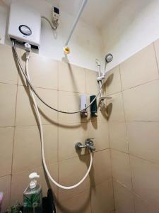 a shower with a hose attached to a wall at Balai Nami in Pajak +33 photos