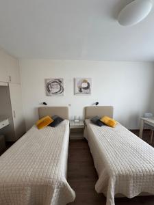 two beds sitting next to each other in a room at Marianna Hotel Apartments in Limassol