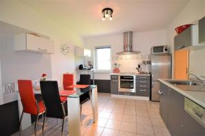 a kitchen with a table and some chairs in it at Ferienwohnung 300 Meter zur Ostsee in Graal-Müritz +12 photos