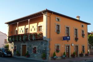 a building with potted plants on the side of it at Posada La Rivera De Escalante in Escalante