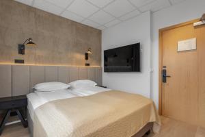 Postel nebo postele na pokoji v ubytování Alva Hotel Brautarholt