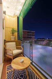a room with a table and a chair on a balcony at Casita de Luna- Affittacamere Bologna in Bologna