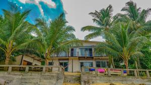 a house on the beach with palm trees at Casa Nice in Kribi