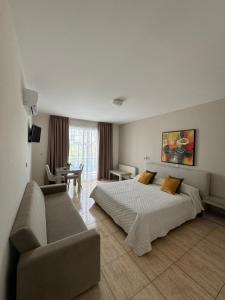 a hotel room with a bed and a couch at Marianna Hotel Apartments in Limassol
