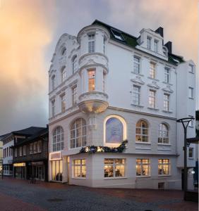 a large white building with flowers in the window at THE GREEN PHOENIX Dortmund Phönixsee in Dortmund