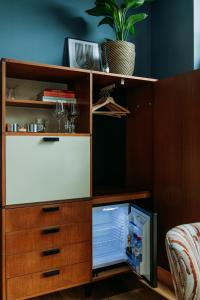 a wooden cabinet with a small refrigerator in it at LeLou in Utrecht