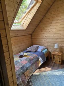 a bedroom with a bed in a wooden cabin at Domek Pod Siodłem in Wetlina