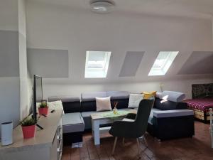a living room with a couch and a table at Penzion a Víno in Břeclav