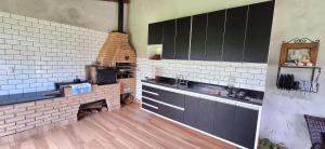 a large kitchen with a brick oven in a room at Sítio Ágape in Santo Antônio do Pinhal