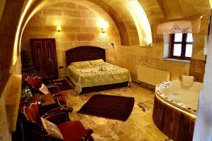 A bed or beds in a room at Avanos Suites