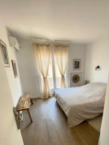 a bedroom with a bed and a window at Spacious house with balcony in Sainte-Maxime