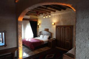 A bed or beds in a room at Avanos Suites
