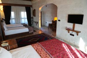 A bed or beds in a room at Avanos Suites