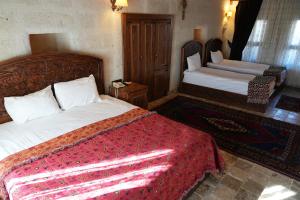 A bed or beds in a room at Avanos Suites