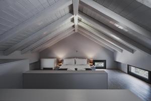 a large bedroom with a bed in a attic at St Aims by Bluesites in Porto Heli