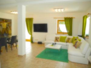 a living room with a couch and a table at Blackforest Life in Urberg