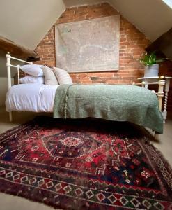 a bedroom with a bed and a brick wall at Old country cottage in Ashbourne +16 photos