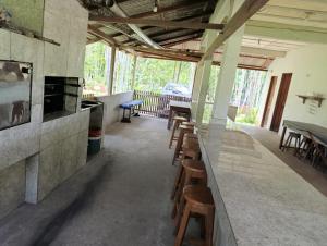 Habitación con bar con sillas y mesas. en Camping em Castanhal para COP 30, en Castanhal