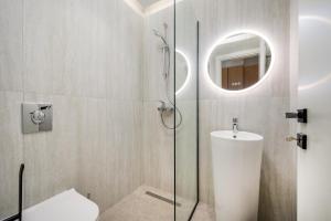 a bathroom with a shower with a toilet and a sink at Beach Luxury Homes - Zoe in Lampi +47 photos