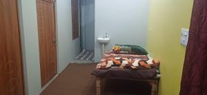 a small room with a bed and a sink at Madhu home stay Sai Sahara Bhavan in Prayagraj
