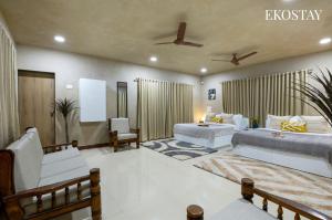 a large living room with two beds and a couch at EKOSTAY - Hazelnut Villa in Alibaug +14 photos