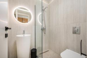a bathroom with a shower and a toilet and a sink at Beach Luxury Homes - Zoe in Lampi