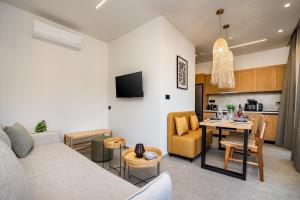 a living room with a couch and a table at Beach Luxury Homes - Zoe in Lampi