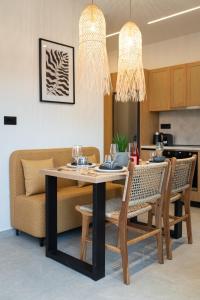a dining room with a table and chairs at Beach Luxury Homes - Zoe in Lampi +44 photos