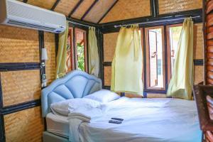 Postel nebo postele na pokoji v ubytování Punpoon resort