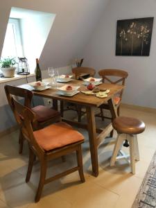 a wooden table and chairs with plates of food on it at Haus Nummer 1, Moselblick in Reil +25 photos