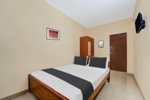 Postel nebo postele na pokoji v ubytování Super Hotel O Chinnamuthu Main Street