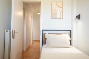 a small bedroom with a bed and a hallway at Smart Home Corfu Maisonette in Alykes Potamou