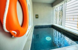an indoor swimming pool with an orange object next to a window at The Segond Hotel in Xagħra