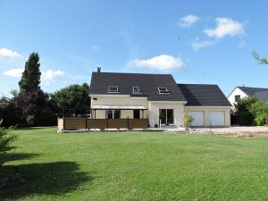 a house with a large lawn in front of it at chambre lit double in Tourville-la-Campagne