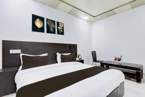 Postel nebo postele na pokoji v ubytování Hotel O Grand Heights